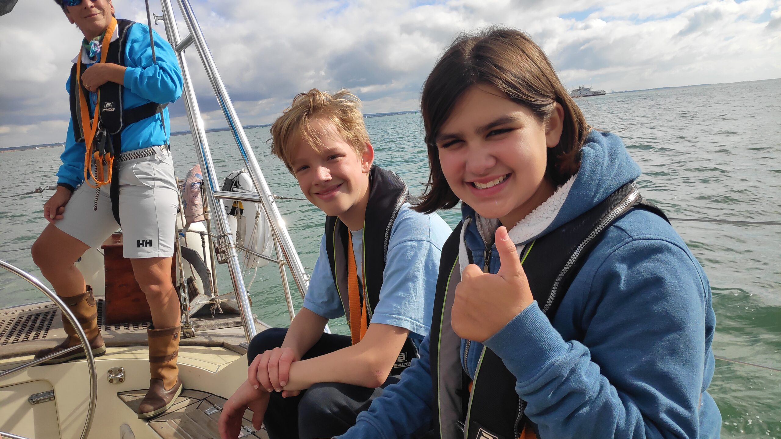 two scouts sailing on a yacht in sunshine